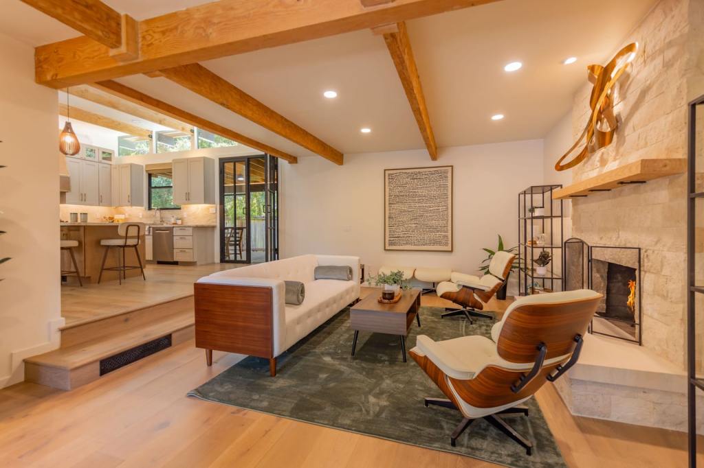 4210 Grand Avenue living room with exposed beams and stone fireplace